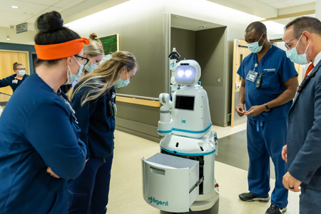 Medical students working with medical robot