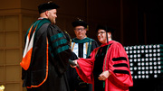 Dr. Seth Bohman (left) receives his degree from Dr. Podolsky.