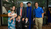 Paul Blazek (in gown) celebrates with his family after receiving his degree.
