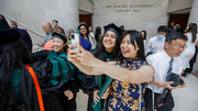 Family and friends take selfies in celebration, including graduating Dr. Anishka Kappalayil (center).