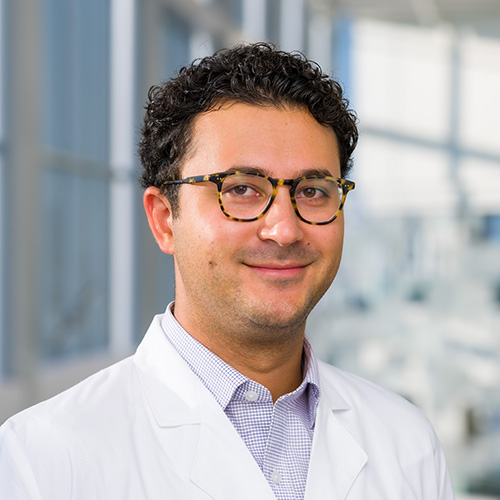 Dr. Siah, a smiling man with dark hair and glasses