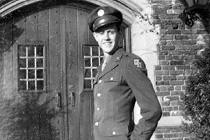 Jack Reynolds in uniform, standing outside a brick building