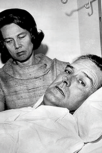 John Connally in bed with Nellie Connally beside him.