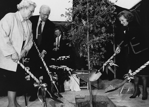 Dignitaries breaking ground with ribbon-decorated shovels