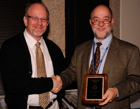 Dr. Greg Fitz, Dean of UT Southwestern Medical School presents award to Dennis Burns, M.D., Professor of Pathology. 