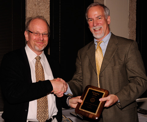 Dr. Greg Fitz, Dean of UT Southwestern Medical School presents award to Stephen Cannon, M.D., Ph.D., Professor of Neurology and Neurotherapeutics. 