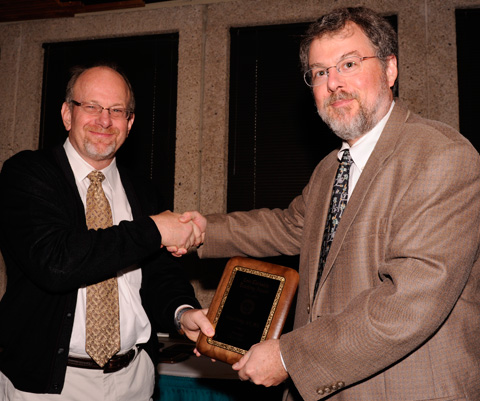 Dr. Greg Fitz, Dean of UT Southwestern Medical School presents award to Michael Dowling, M.D., Ph.D., MSCS, Associate Professor of Pediatrics and Neurology and Neurotherapeutics