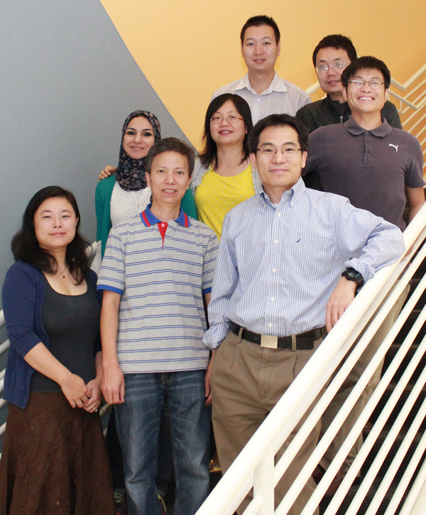 Chun-Li Zhang, Ph.D. (first on the right, front row) and his team of researchers studying the mechanisms of neuronal regeneration and recovery after brain injury. Front row from l to r: Tong Zang, Meng-Lu Liu; second row from l to r: right to left: Amel Ahmed, Yuhua Zou, Wenze Niu; top row from l to r: Dexiang Ban, Chao Guo.