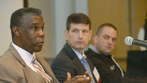 Zachary Thompson, Director of Dallas County Health and Human Services, makes a point as fellow panelists Drs. Frederick P. Cerise and Alexander Eastman (center, right) listen during the complex emergencies presentation.