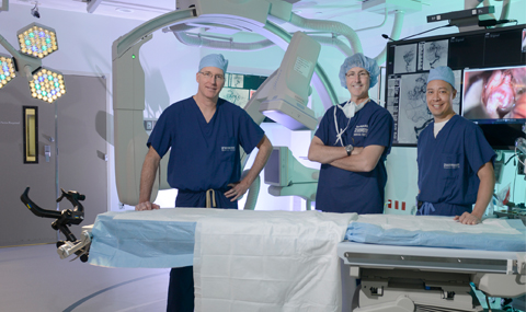 Neurosurgeons Dr. Glenn Pride, left, Dr. Hunt Batjer, center, and Dr. Babu Welch, right
