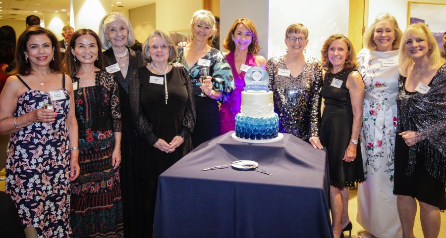 10 FWC Past Presidents pose around cake for 80th anniversary gala