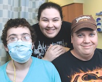 Josiah Ferrell, left, with his sister Brianna Ferrell, and father, John Ferrell