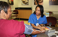 UT Southwestern employee checks a patient's blood pressure