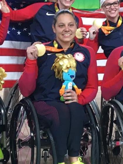 Darlene Hunter holds the gold medal she earned in wheelchair basketball at the 2016 Summer Paralympics in Rio de Janeiro. Ms. Hunter is now helping UT Southwestern raise awareness about the benefits of adaptive sports for people with mobility, cognitive, or visual impairments.