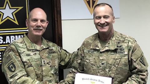 Dr. Robert E. Suter (right) receives the Lewis Aspey Mologne Award from Maj. Gen. William Lee, Commander of the 3rd Medical Command (Deployment Support), at Camp As Sayliyah.
