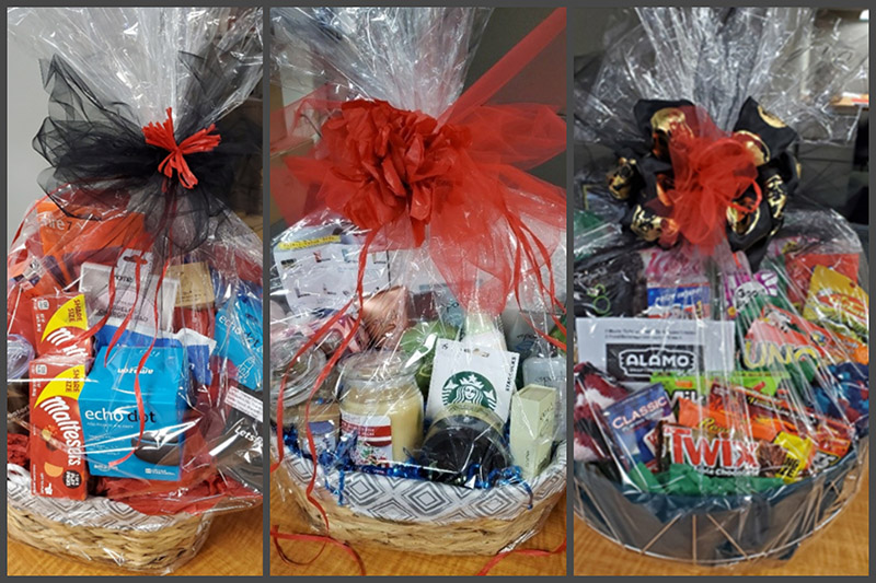 Three decorated gift baskets filled with snacks