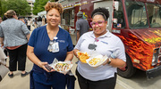 Lisa DeBlanc (left) and Taylor Curry-Peoples (right) display their freshly prepared baked potatoes.