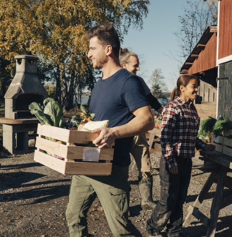 man carries box of produce