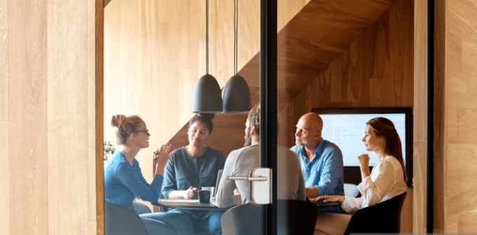 Men and women sit at a table and talk