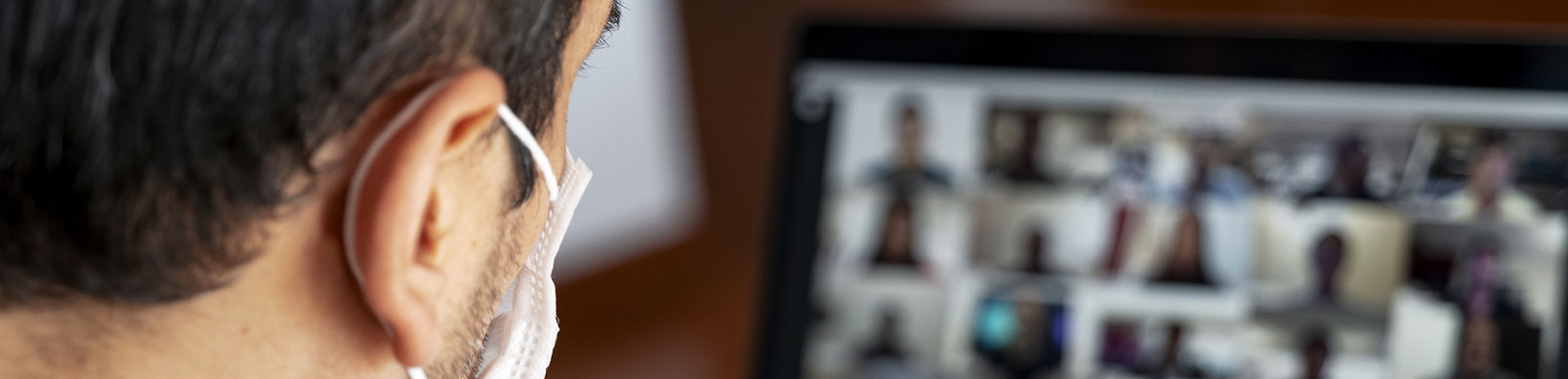 A man wearing a mask in a virtual meeting