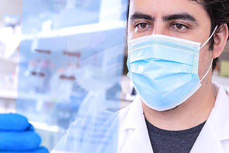 A man wearing a mask in research lab
