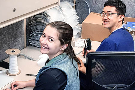 Two woman and a guy volunteering during pandemic