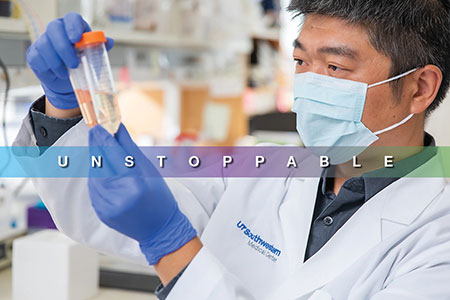 Unstoppable: A researcher wears blue gloves and a mask and examines two test tubes
