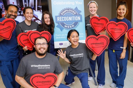 UTSW employees passing out food bags at the HealthFest