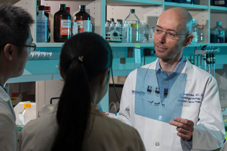 A male medical professional holding an x-ray in the operating room 