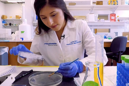 A femal researcher in the lab working on research