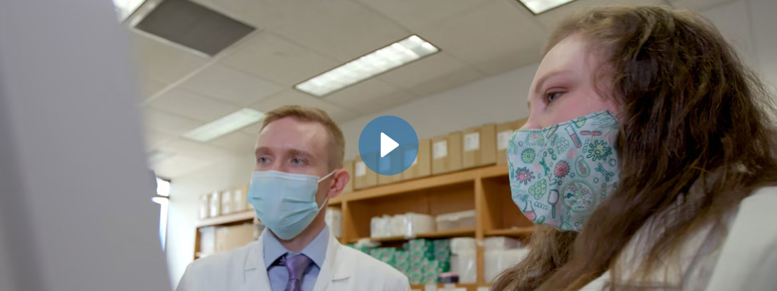 Two doctors wearing masks in lab