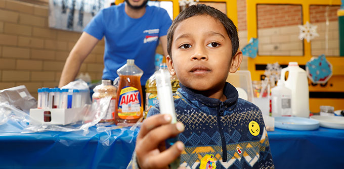 A little boy holding object at health fair