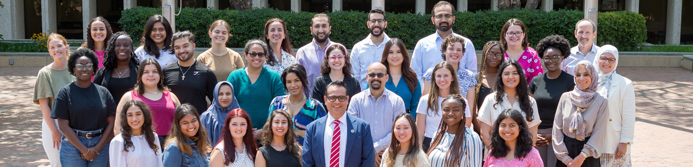 A group of men and women medical professionals taking a photo