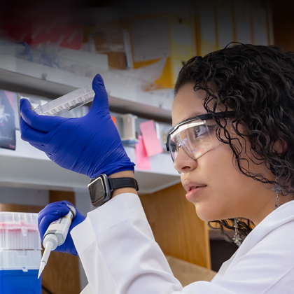 A male researcher examining test tubes