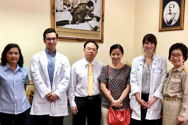 Taylore King stands with colleagues at a hospital in Thailand