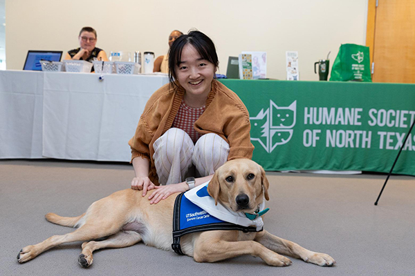 Woman posing with yellow lab, Tia