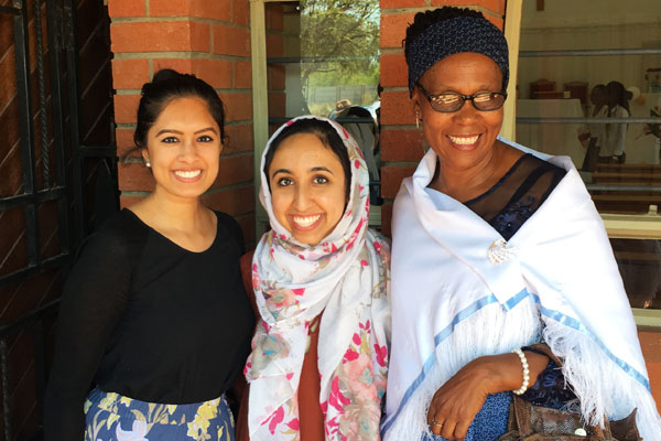 Sidrah Shah stands with two colleagues at the clinic in Botswana