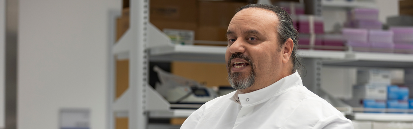 Dr. Azab speaking in a lab