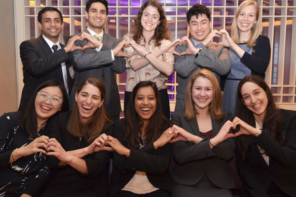 Jamie Pfaff and other medical students interested in cardiology from all over the country make heart shapes with their hands.