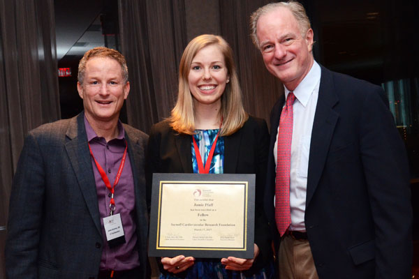 Jamie Pfaff receives the Sarnoff Cardiovascular Research Fellowship award from her mentors, UT Southwestern Cardiologists Dr. James de Lemos and Dr. Joseph Hill, Chief of Cardiology.