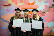 Physician Assistant Studies graduates (from left) Alexa Pokluda, Peyton Travis, and Megan Thomas pose with their diplomas for a photo.
