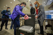 Pharmacists unload doses of the vaccine ahead of staff arrivals.