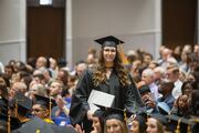 Prosthetics and Orthotics graduate Victoria “Tori” Moses heads back to her seat after receiving her diploma.