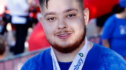 A survivor smiles as he completes the walk with a medal.