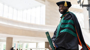 Lister DeBinya, M.D., flashes a joyful smile upon receiving his diploma.