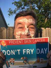 Patrick Wascovich, Sr. Communications Specialist for Communications, Marketing, and Public Affairs, slathers on the sunscreen.