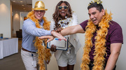 Gold pin recipient Anita Hosoda and colleagues pose with fun photo props.