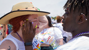 Parade: At the parade, UTSW employee Katina Bertoch gets colorful sequins placed on her face by visitor Jon Woods.