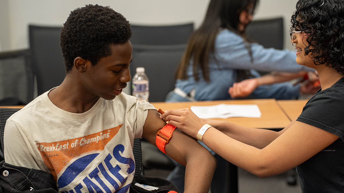 Students practice using a tourniquet.