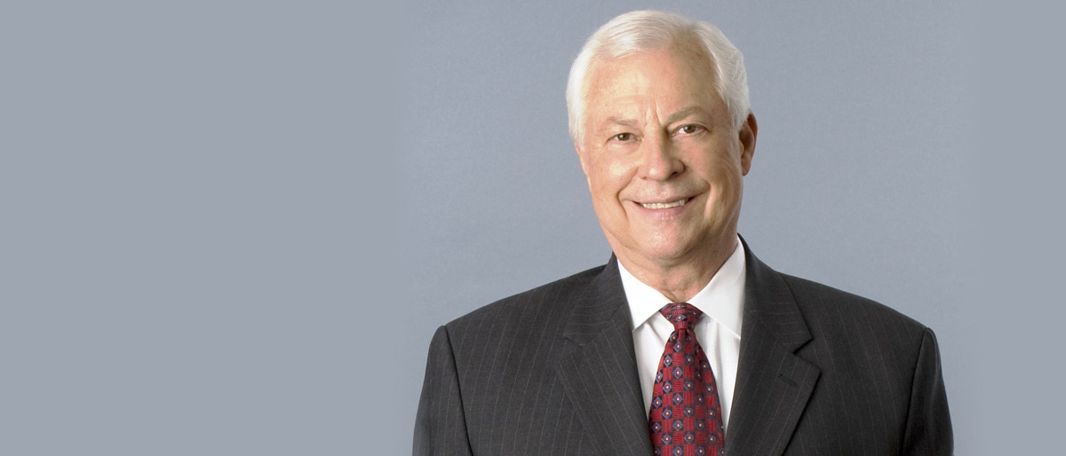 Man with white hair and black suit